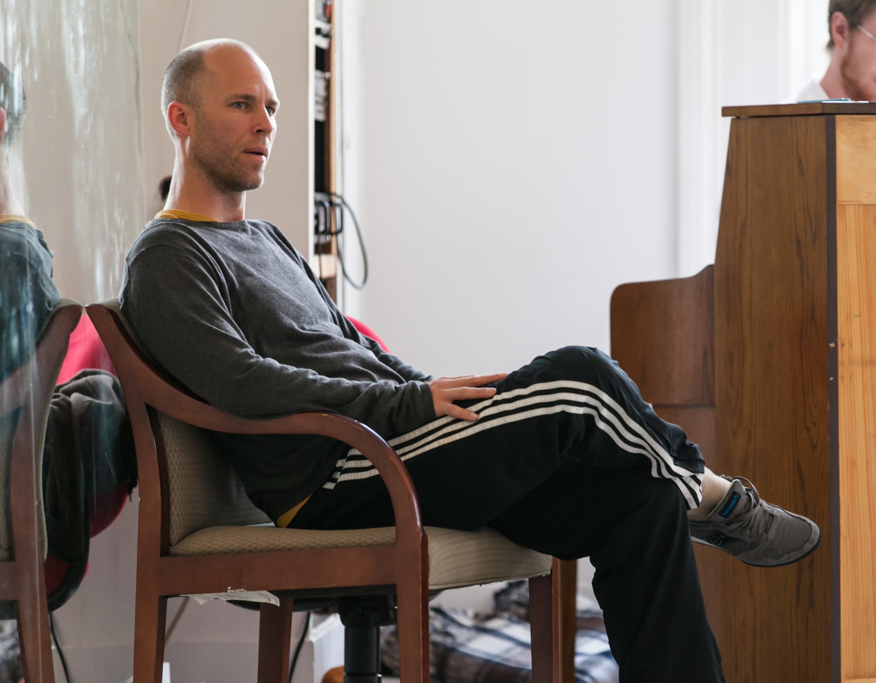 Christian Burns seated, observing a class