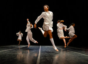 BFA students jumping together onstage