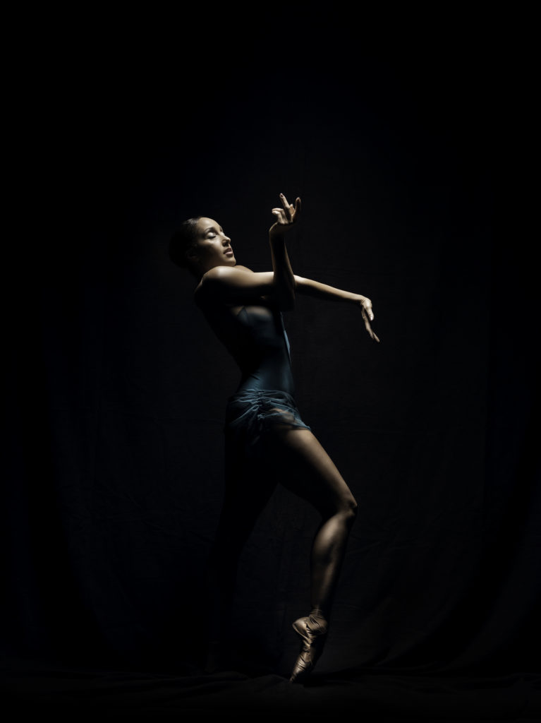 Company Dancer Caroline Rocher with arms entwined in front of her