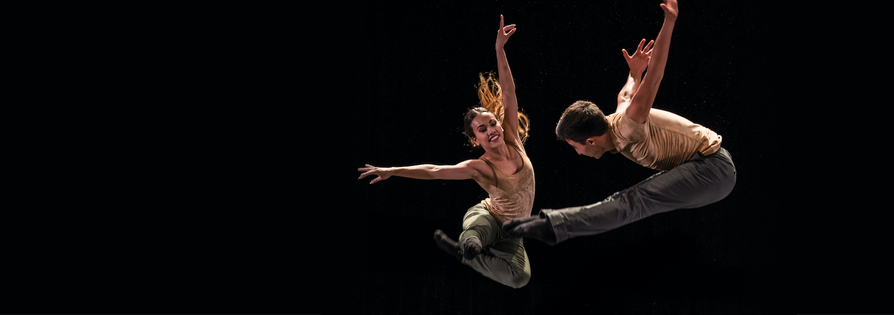 Two BFA students jumping in flight together