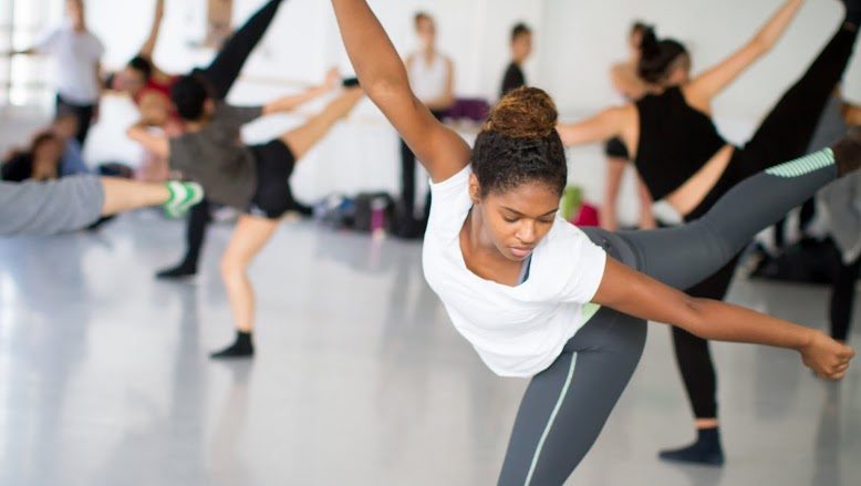 A student in arabesque during a contemporary class