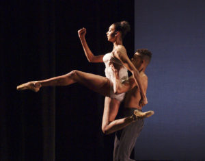 Two LINES Ballet Summer Program students partnering and performing on stage