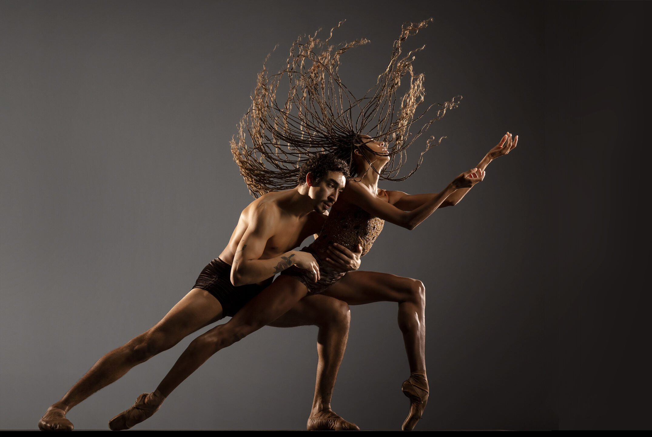 LINES Ballet company artists Adji Cissoko and Shuaib Elhassan partnering, Adji en pointe in a lunge