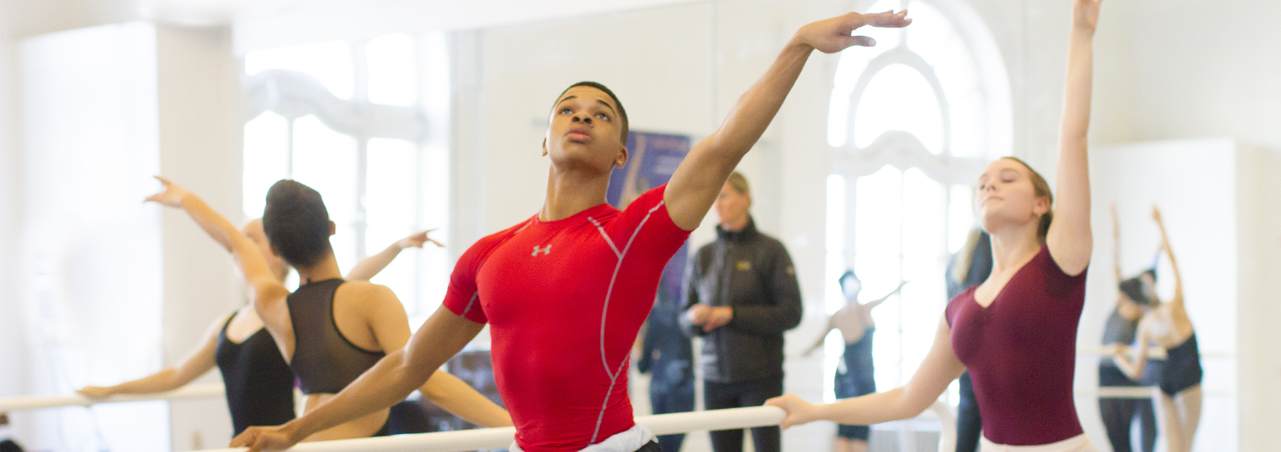 Teens students dancing at the barre in a ballet class at LINES Dance Center