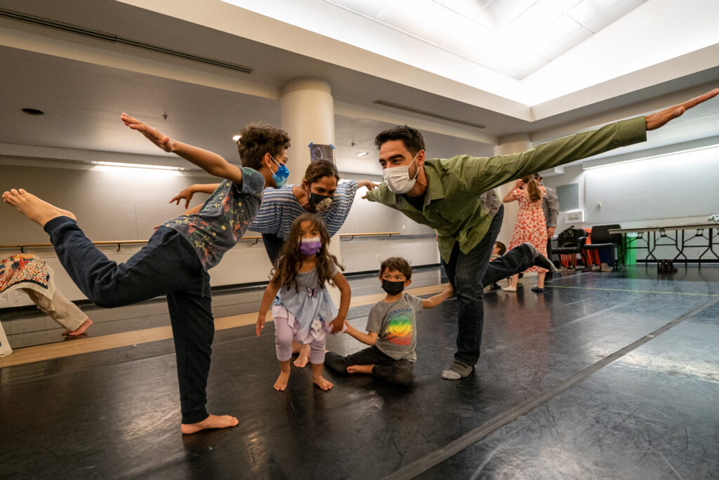 Former LINES Ballet Family Experience participants dancing together in a studio at the Blue Shield of California Theater at YBCA