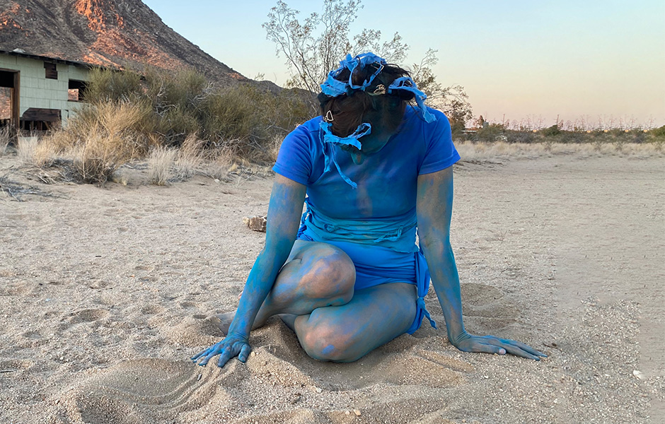 Kneeling Elizabeth Bouboin in blue paint