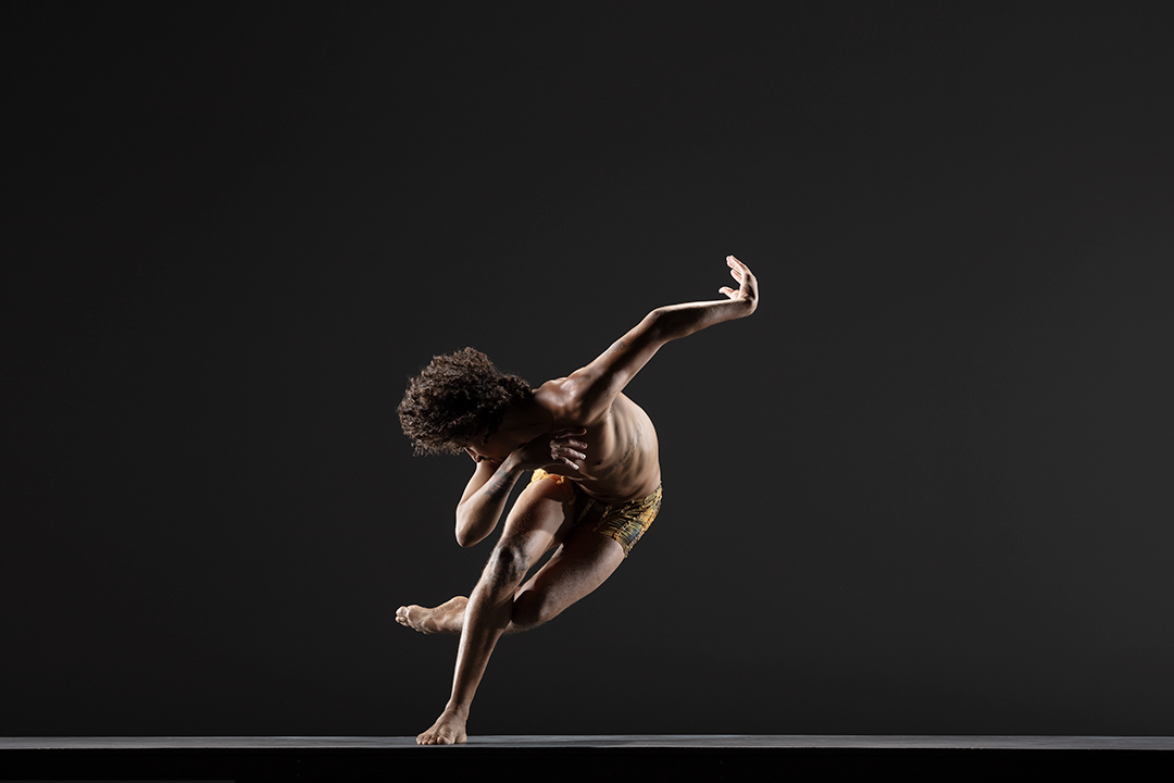 LINES Ballet Company Dancer Shuaib Elhassan dancing, balancing on one while in plié with other leg sweeping back and bent at the knee