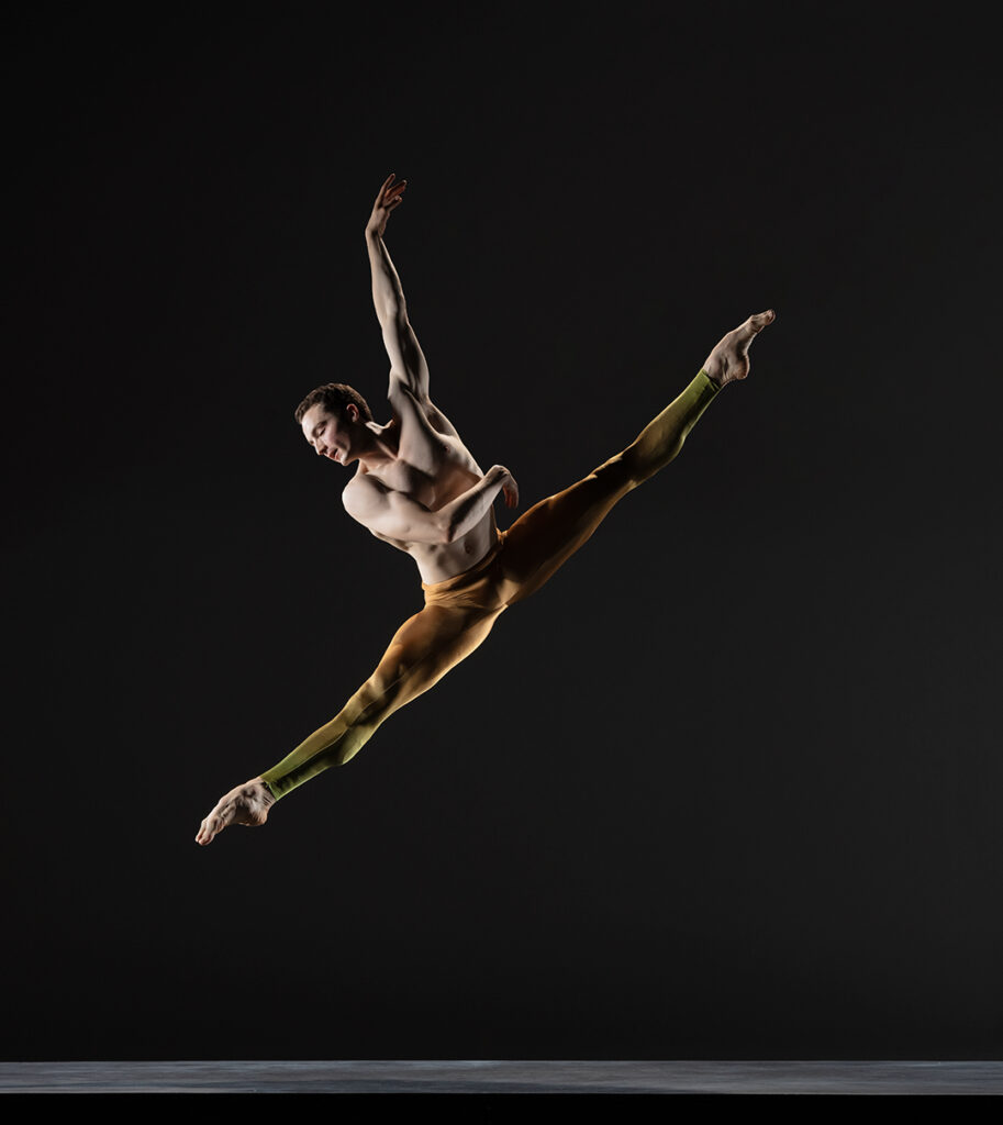 LINES Ballet Company Dancer Theo Duff-Grant jumping with legs in a side split