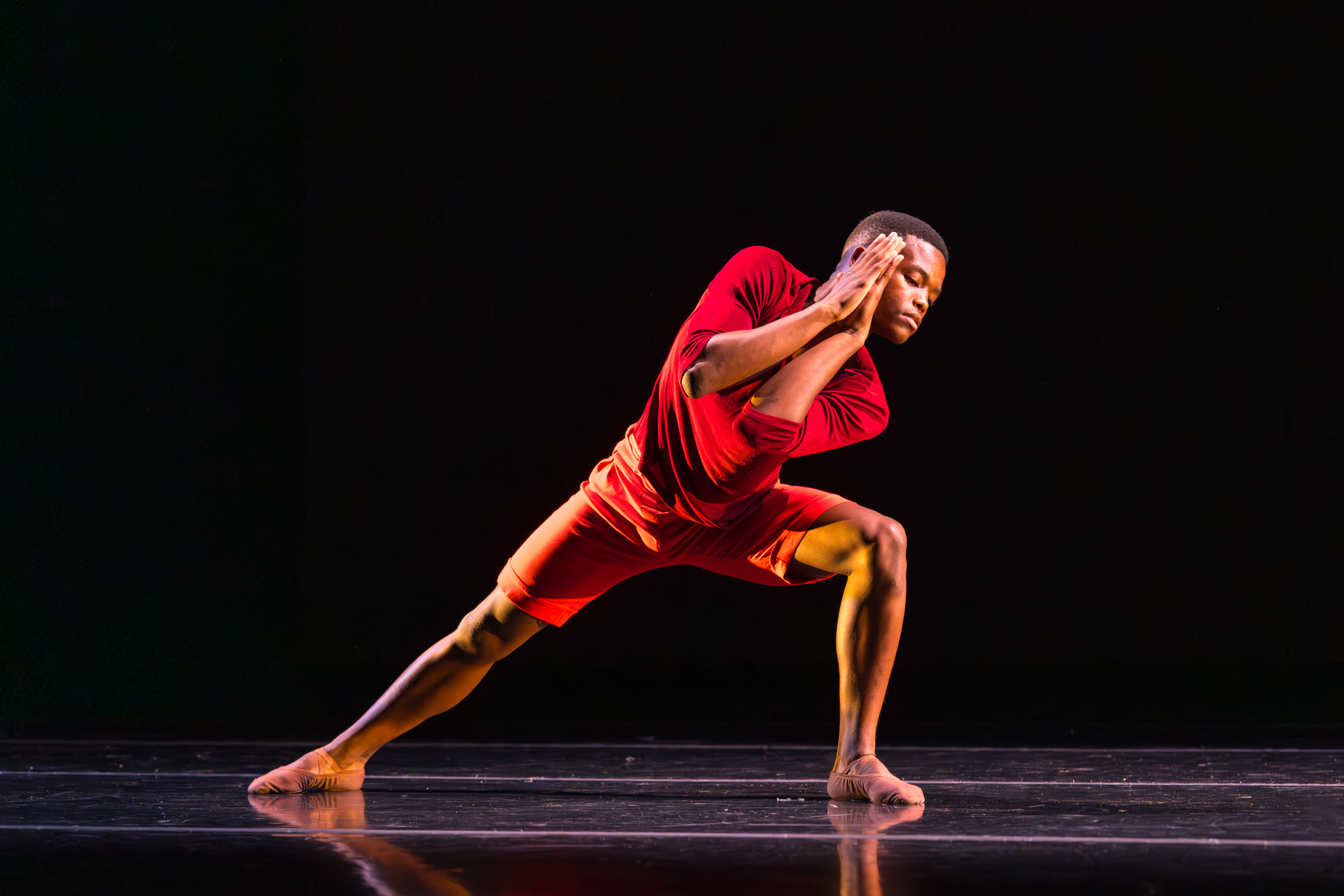 A dancer performing a piece by Carmen Rozestraten on stage in a Pre-Professional LINES Ballet Summer Program Showcase