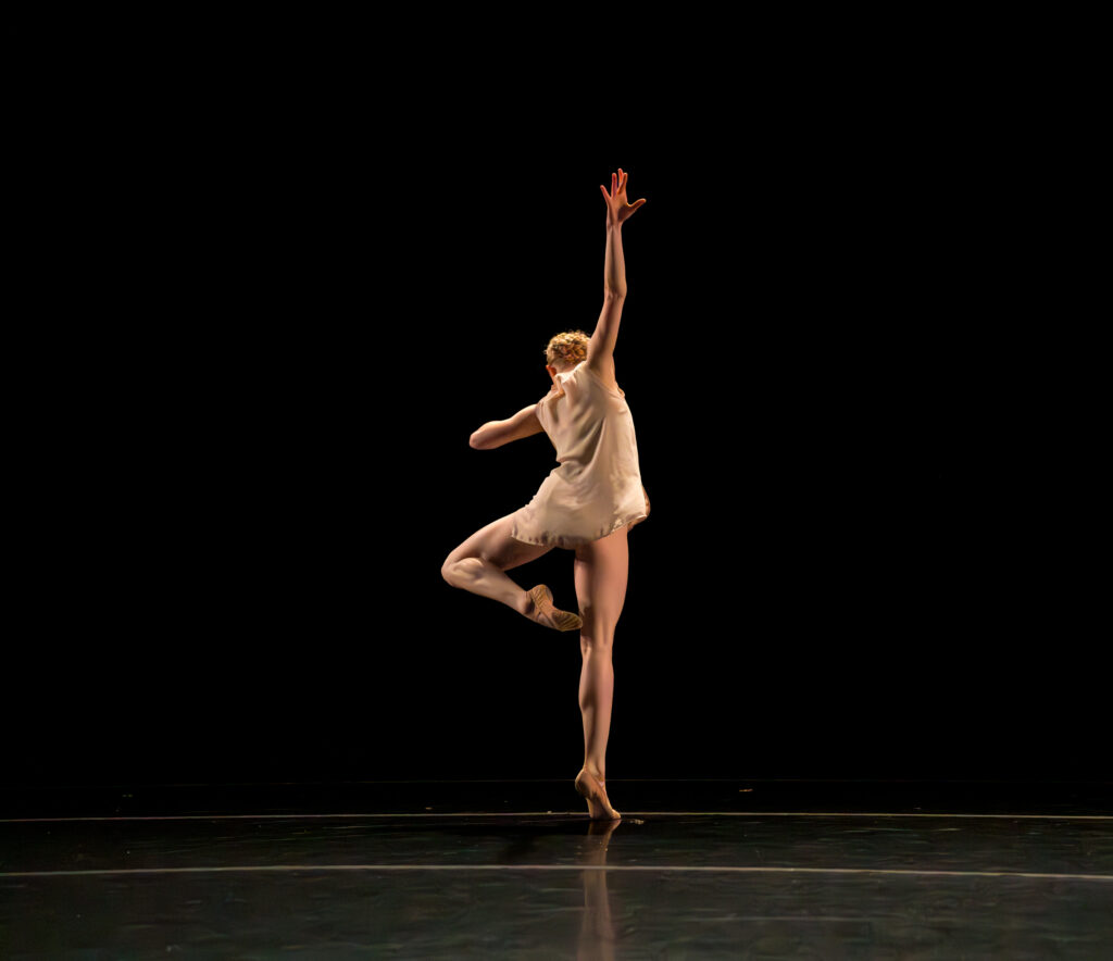 A dancer performing a piece by Gregory Dawson on stage in a Pre-Professional LINES Ballet Summer Program Showcase