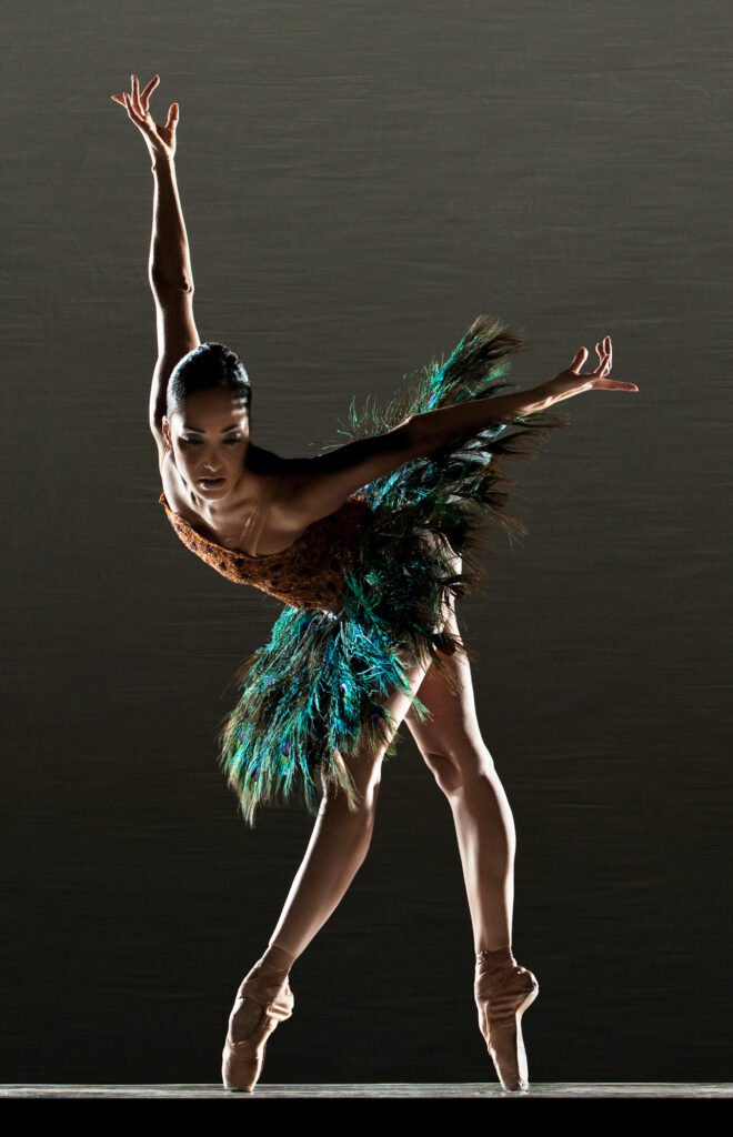 Dancer Caroline Rocher en pointe wearing a peacock-like tutu