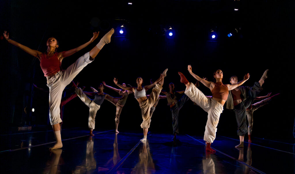 Two LINES Training Program dancers perform onstage a work by Alejandro Perez wearing neutral toned costumes