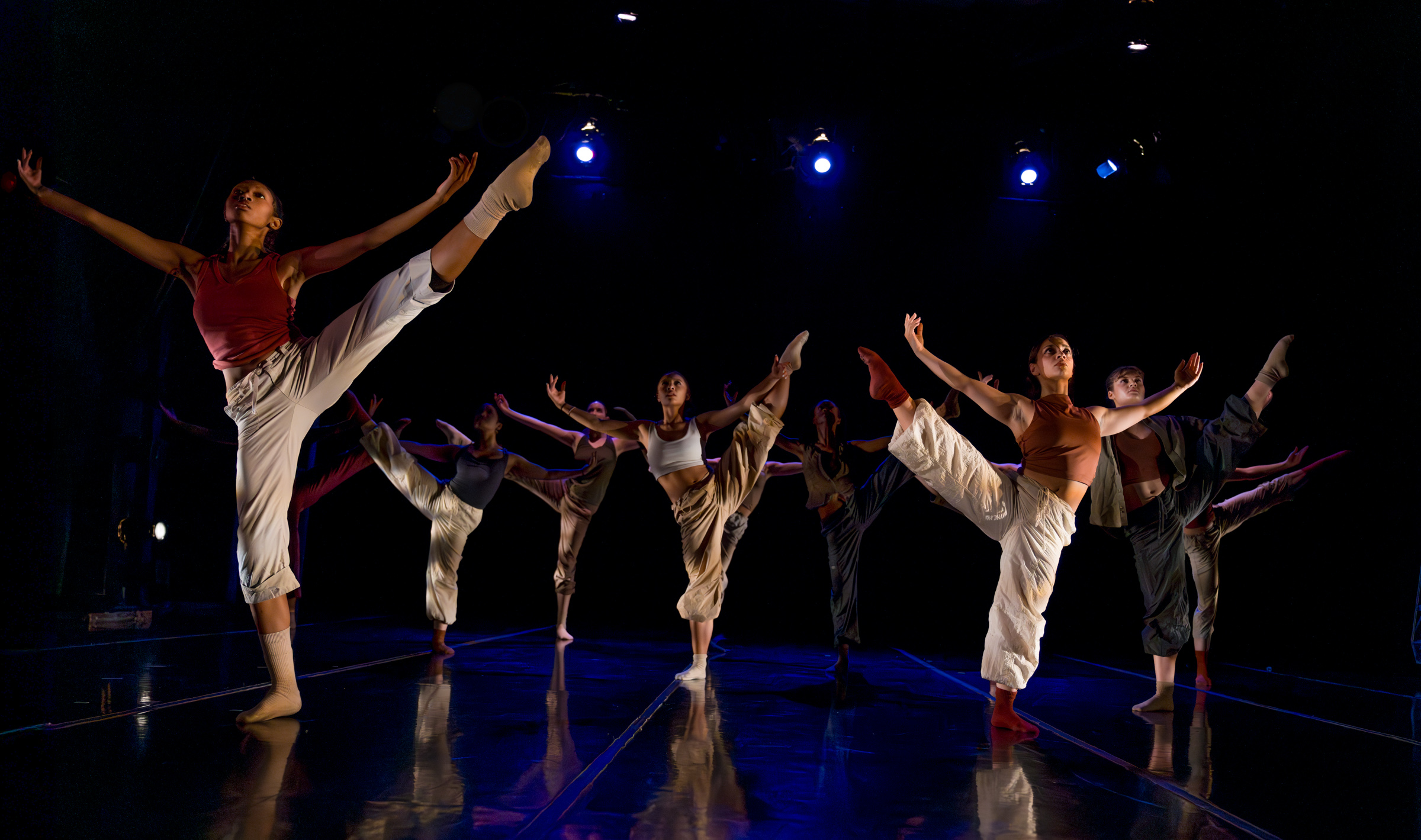 Two LINES Training Program dancers perform onstage a work by Alejandro Perez wearing neutral toned costumes