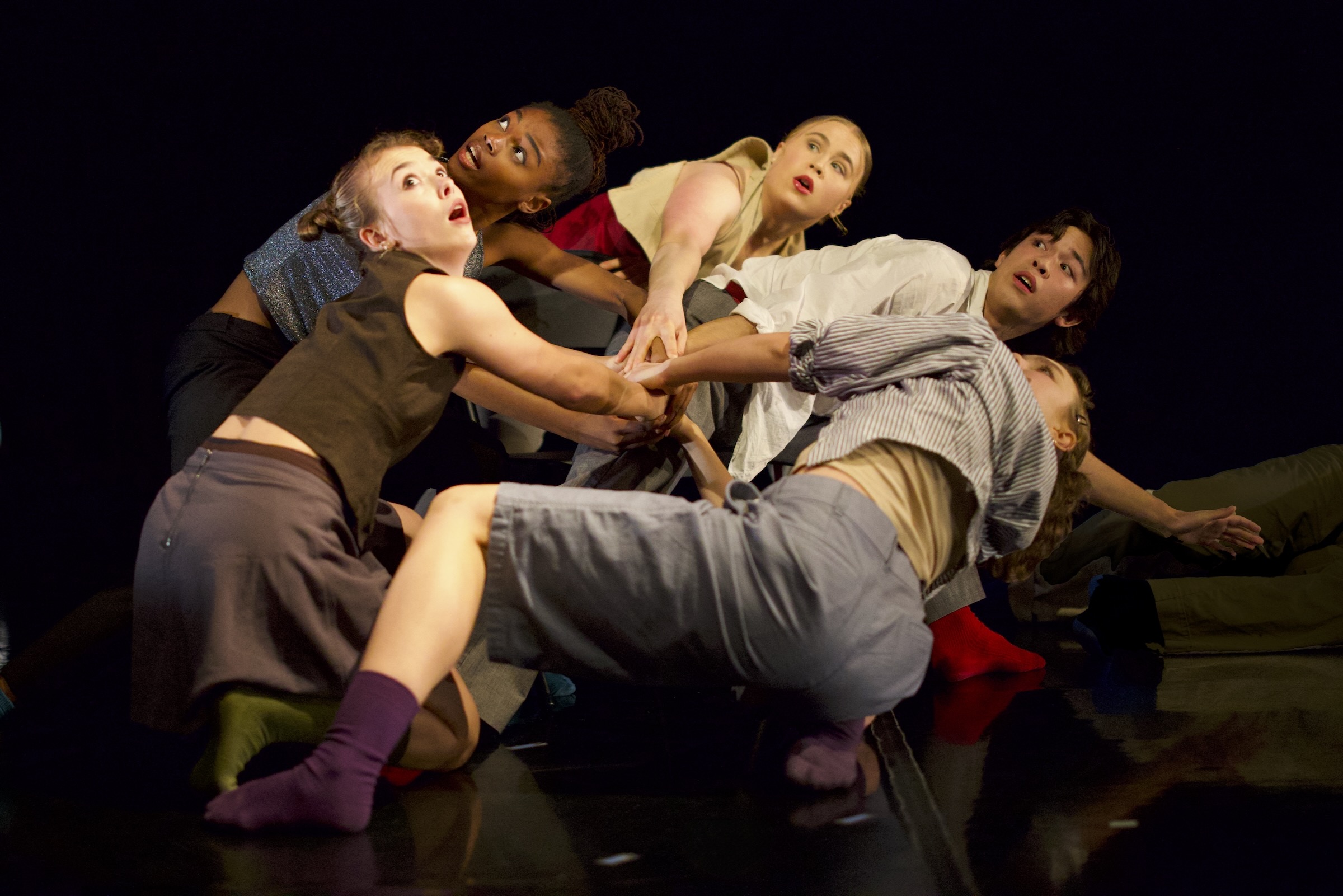LINES Ballet Training Program students performing a work on stage choreographed by Natasha Adorlee while wearing earth tones