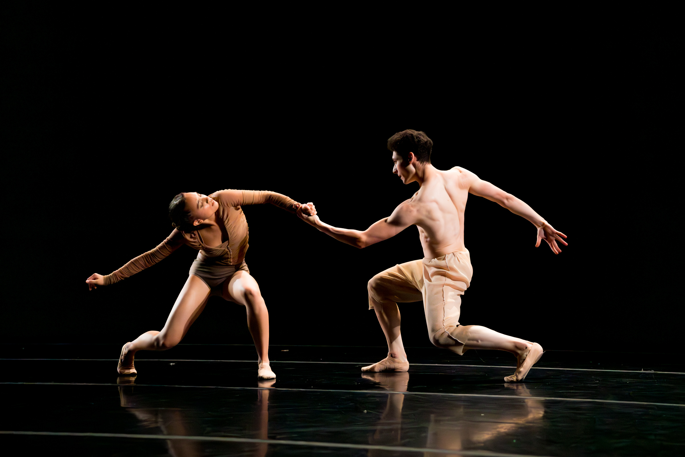 Two dancers performing a piece by Gregory Dawson on stage in a LINES Ballet Summer Program Showcase