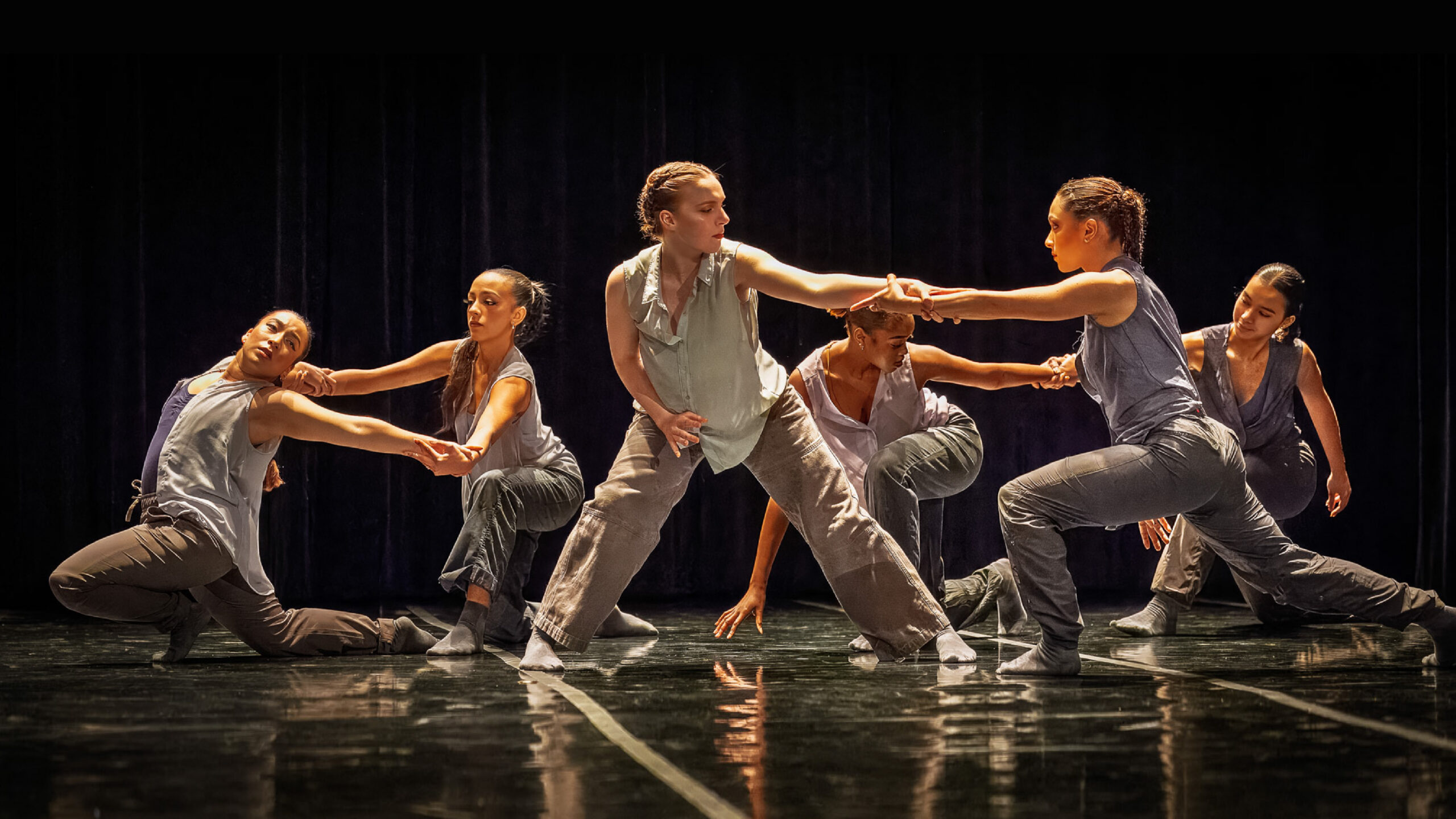 LINES BFA Class of 2027 dancers perform onstage. 6 dancers dressed in neutral tones are paired off, holding hands in counterbalance.